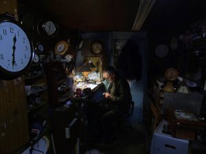 Photo of a dimly lit room of a watchmaker working by Irish Artist David O'Rourke